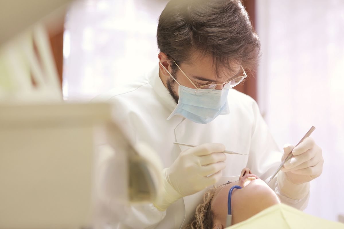 Dentist attending to a patient at an urgent dental visit