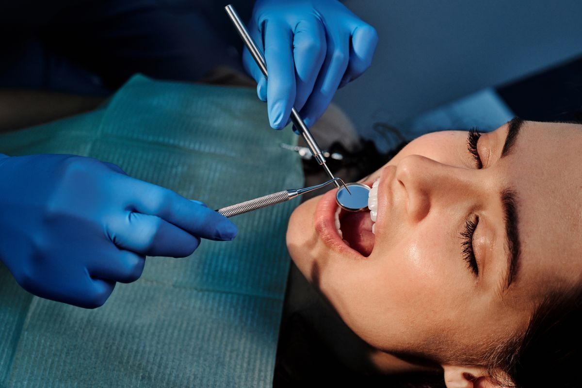 Close-up of a dentist performing precise dental treatment