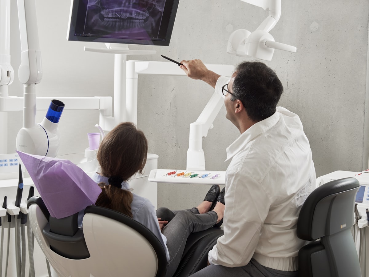 Dentist reviewing scan results with a patient chairside