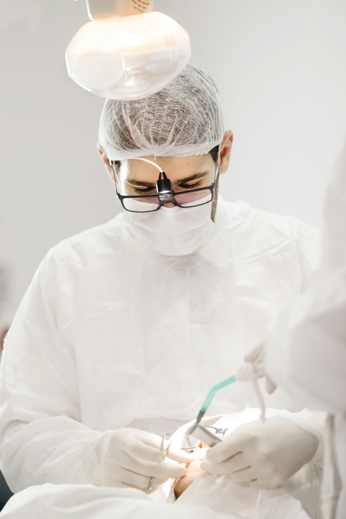 Oral surgeon performing a surgical tooth extraction